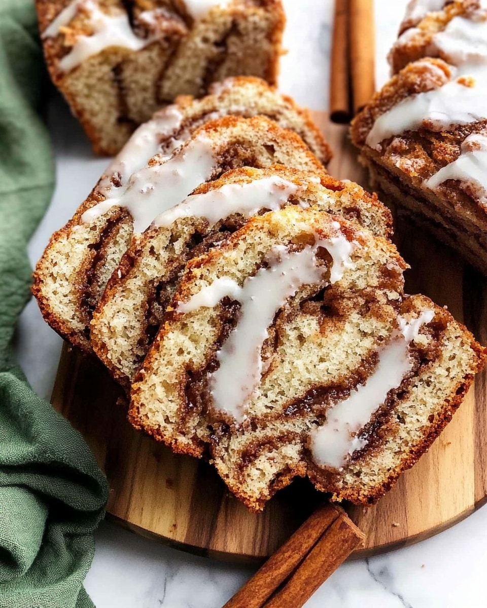 The image shows several slices of a moist cinnamon swirl bread with a light brown crumb and dark brown cinnamon swirls running through each slice. The bread has a slightly golden crust with a white icing glaze drizzled unevenly on top, creating glossy streaks. The slices are placed on a wooden board on a white marbled surface, with a green cloth napkin to the side and two cinnamon sticks nearby. One slice is partially torn, showing the soft texture inside, while the rest are neatly sliced and stacked near the top of the image. photo taken with an iphone --ar 4:5 --v 6.1